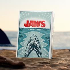 La arena parece moverse cuando aparece esta baraja Jaws cartas premium, con el tiburón emergiendo en una caja que ya funciona como pequeña pieza de exposición. La baraja Jaws cartas premium concentra en formato de bolsillo la tensión marina