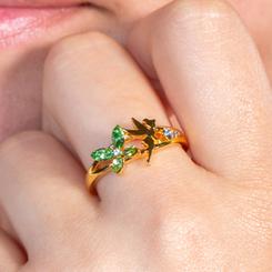 Magia que chispea en verde con el Tinker Bell Ring, un anillo de acabado dorado que combina la silueta de Campanita en metal dorado con pétalos de cristal talla marquesa y destellos transparentes