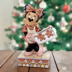 En esta encantadora creación de Jim Shore, Minnie Mouse deslumbra con un vestido y lazo inspirados en galletas de jengibre, mientras comparte sus recién horneadas delicias navideñas.