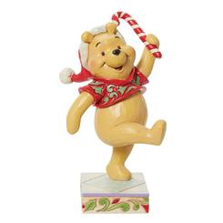 Figura de Winnie the Pooh sosteniendo un bastón de caramelo para celebrar la Navidad. Diseñado por el galardonado artista y escultor Jim Shore para la marca Disney Traditions.